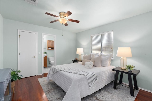 512 Mitchell Dr, Hutto, TX 78634 - bedroom with wood finished floors, ensuite bathroom, and a ceiling fan