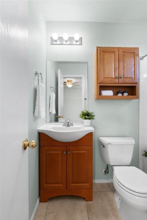 bathroom with tile patterned floors, vanity, and toilet