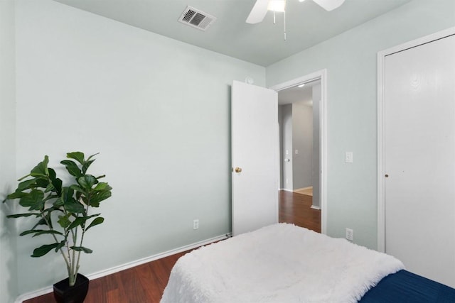 bedroom with ceiling fan and dark hardwood / wood-style floors