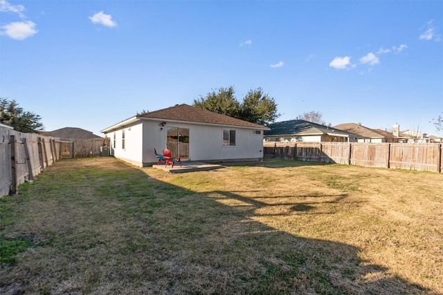 back of property with a patio and a yard