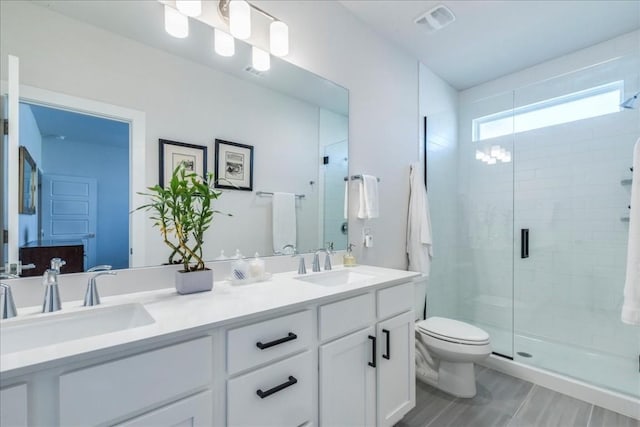 bathroom with vanity, an enclosed shower, and toilet