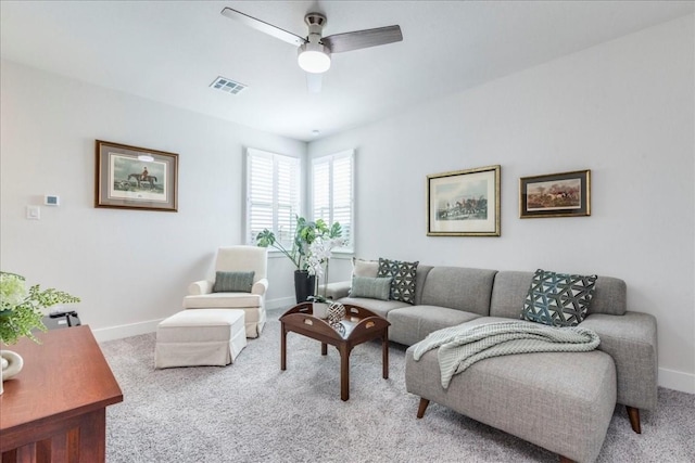 living room with ceiling fan and carpet