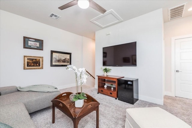 living room with ceiling fan and light colored carpet