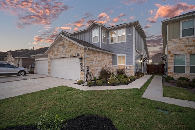 view of front of home with a garage and a lawn