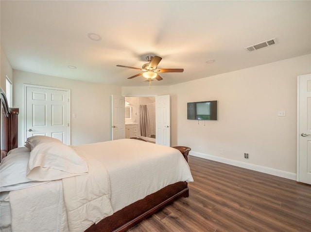 bedroom featuring connected bathroom, dark wood-type flooring, and ceiling fan