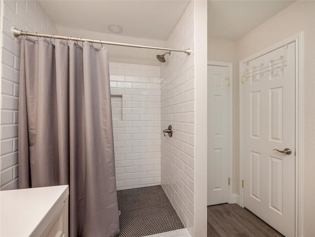 bathroom with hardwood / wood-style flooring, vanity, and a shower with shower curtain