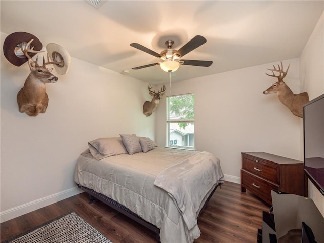 bedroom with dark wood-type flooring and ceiling fan