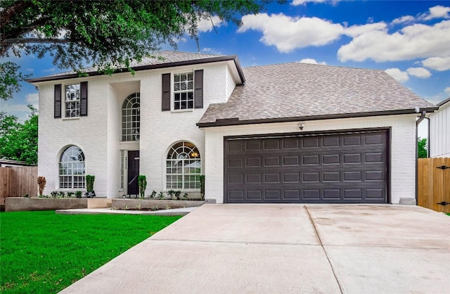 front of property featuring a garage and a front lawn