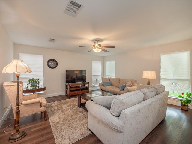 living room featuring dark hardwood / wood-style floors and ceiling fan