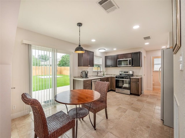 dining area featuring sink and plenty of natural light