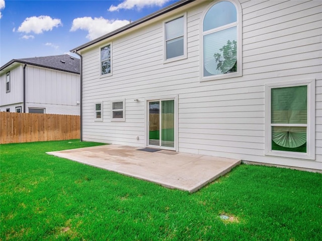 back of property featuring a yard and a patio area