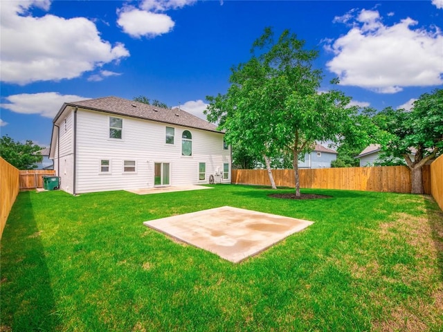 back of house with a yard and a patio area