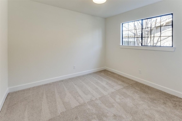 spare room featuring light colored carpet