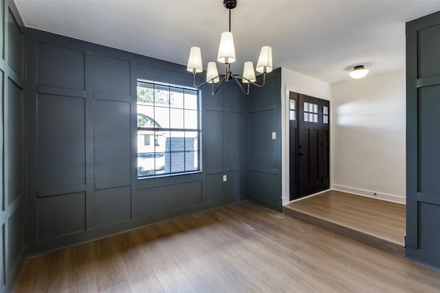 foyer with a notable chandelier and light hardwood / wood-style flooring