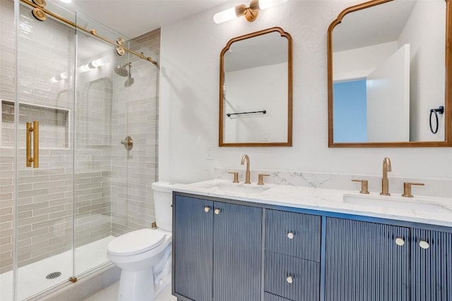 bathroom featuring vanity, an enclosed shower, and toilet