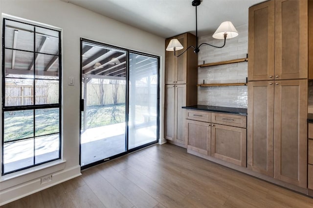 interior space featuring dark wood-type flooring and a healthy amount of sunlight