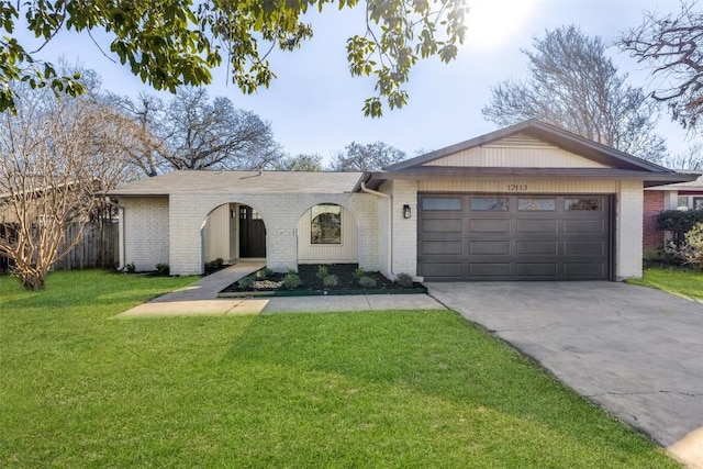 ranch-style home featuring a garage and a front yard