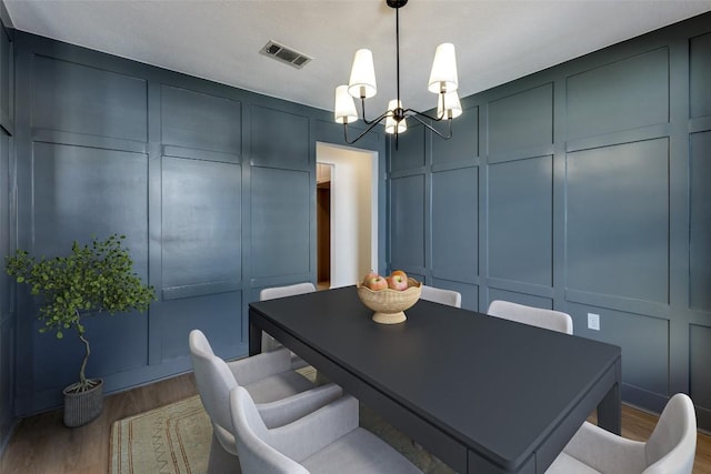 dining space with a chandelier and hardwood / wood-style floors