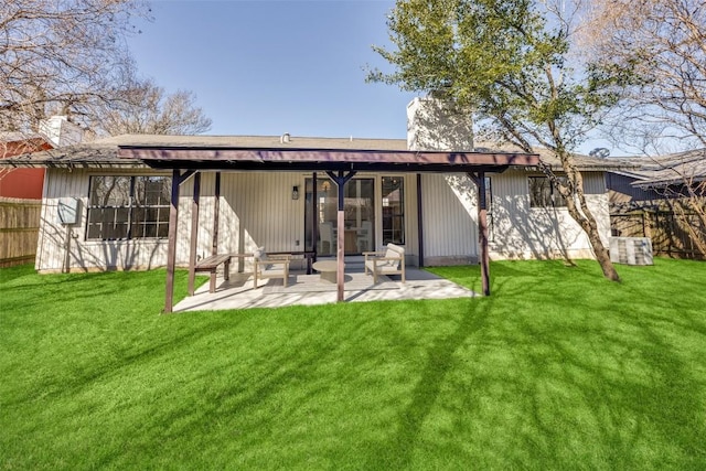 back of house with a patio and a yard