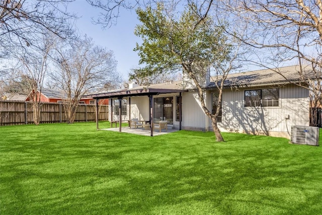 rear view of house featuring central AC unit, a patio area, and a lawn