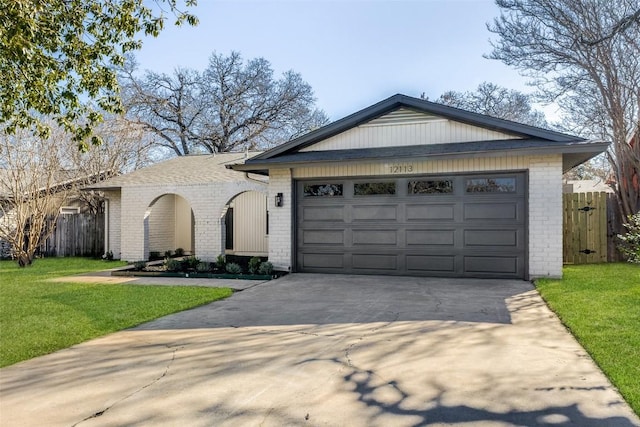 ranch-style home featuring a garage and a front lawn