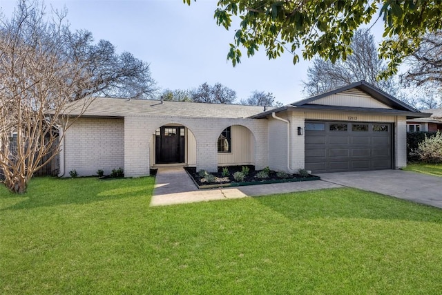 ranch-style home featuring a garage and a front lawn