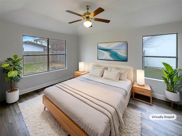 bedroom with dark wood-type flooring and ceiling fan