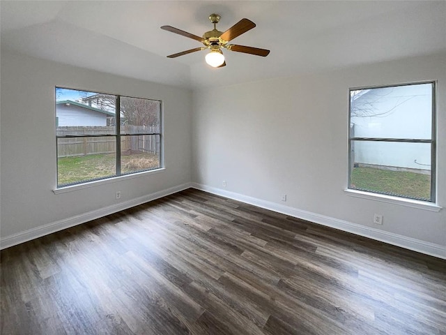 unfurnished room with dark wood-type flooring, ceiling fan, and a healthy amount of sunlight