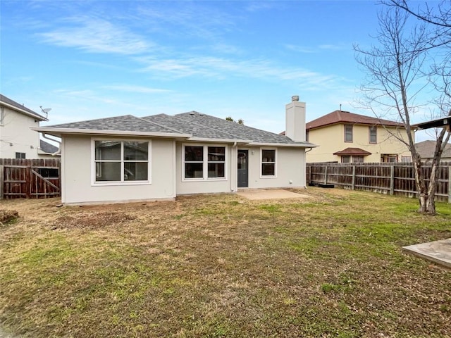 back of house with a lawn and a patio area