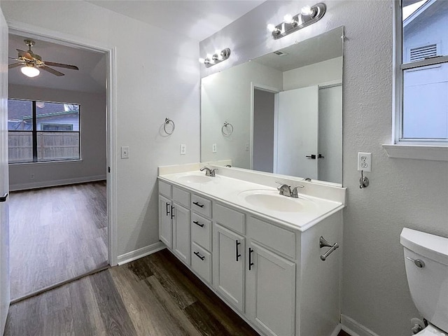 bathroom with vanity, hardwood / wood-style floors, toilet, and ceiling fan