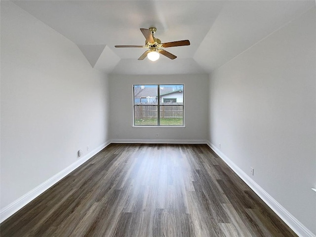 unfurnished room featuring vaulted ceiling, dark hardwood / wood-style floors, and ceiling fan