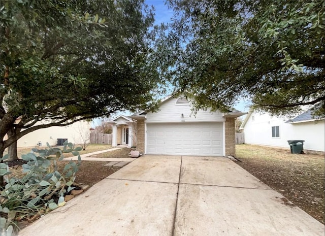 1406 Rio Bravo Loop, Leander, TX 78641 - view of front facade with brick siding, concrete driveway, and an attached garage