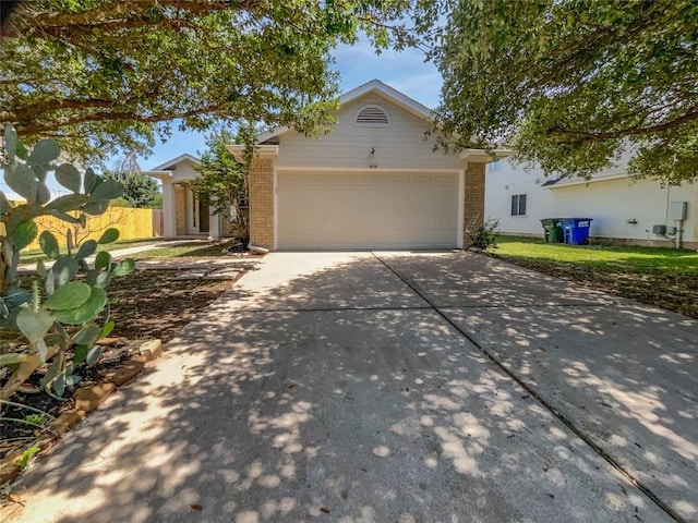 1406 Rio Bravo Loop, Leander, TX 78641 - single story home featuring brick siding, concrete driveway, and a garage
