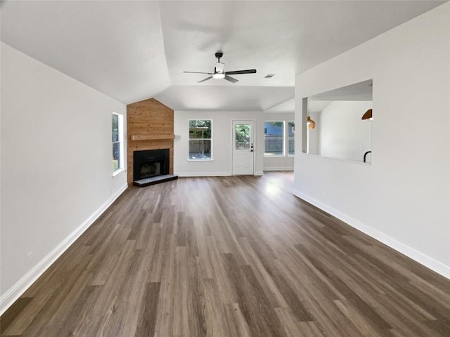 1406 Rio Bravo Loop, Leander, TX 78641 - unfurnished living room featuring vaulted ceiling, ceiling fan, dark wood-style flooring, and a fireplace