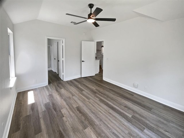 1406 Rio Bravo Loop, Leander, TX 78641 - unfurnished bedroom featuring vaulted ceiling, dark wood-style flooring, ceiling fan, and ensuite bath