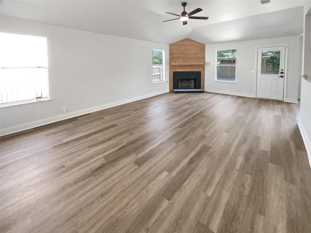 1406 Rio Bravo Loop, Leander, TX 78641 - unfurnished living room with a ceiling fan, wood finished floors, a large fireplace, and lofted ceiling