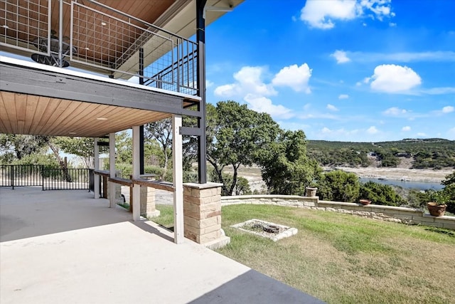 view of yard featuring a water view and a patio area