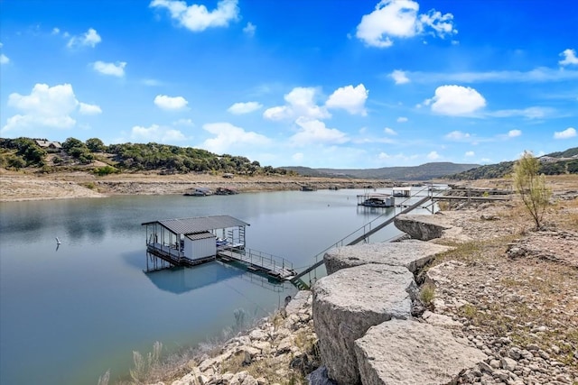 view of dock featuring a water and mountain view