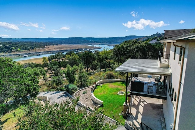 drone / aerial view featuring a water and mountain view