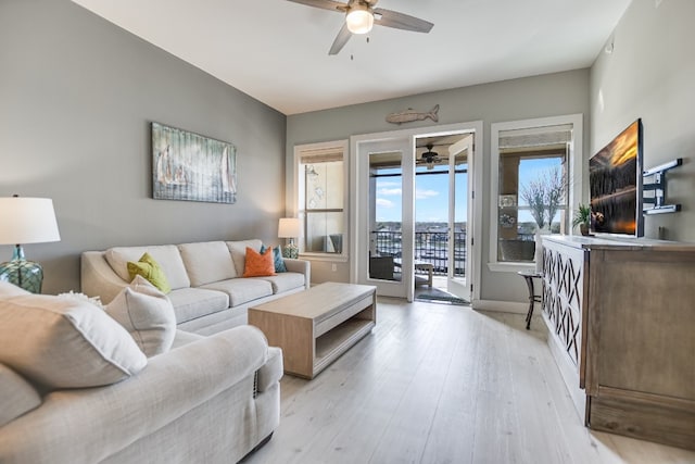 living room with ceiling fan and light hardwood / wood-style floors