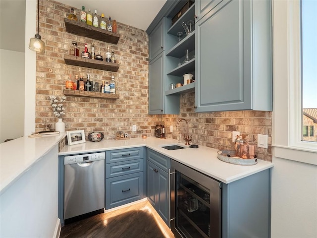 bar with wine cooler, dark wood-type flooring, sink, stainless steel dishwasher, and pendant lighting