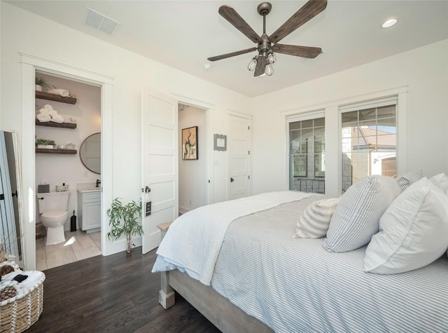 bedroom featuring dark hardwood / wood-style floors, ceiling fan, and ensuite bathroom