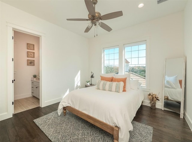 bedroom with ceiling fan, dark hardwood / wood-style floors, and ensuite bath