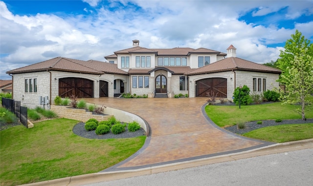 102 Canyon Turn Trl, Austin, TX 78734 - mediterranean / spanish home featuring an attached garage, stone siding, driveway, a front lawn, and a chimney