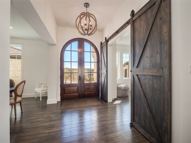 102 Canyon Turn Trl, Austin, TX 78734 - foyer entrance with a healthy amount of sunlight, a chandelier, a barn door, and dark wood-type flooring