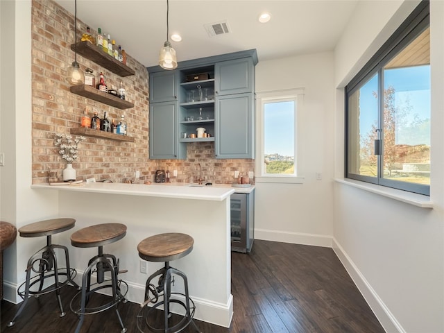 102 Canyon Turn Trl, Austin, TX 78734 - bar with visible vents, dark wood-style flooring, baseboards, wet bar, and wine cooler