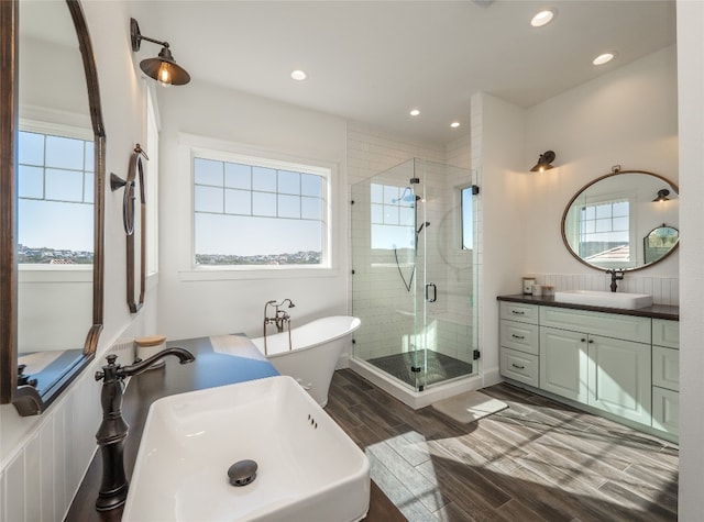 102 Canyon Turn Trl, Austin, TX 78734 - bathroom featuring a stall shower, a freestanding bath, plenty of natural light, and wood finished floors