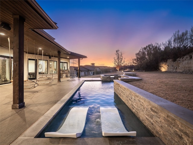 102 Canyon Turn Trl, Austin, TX 78734 - pool at dusk with an in ground hot tub, an outdoor pool, and a patio