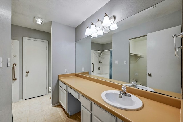 bathroom with vanity, toilet, tile patterned flooring, and a shower with door