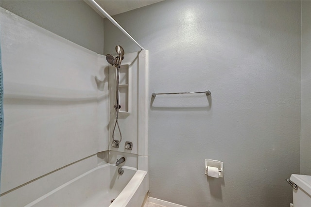 bathroom with toilet and shower / bathing tub combination